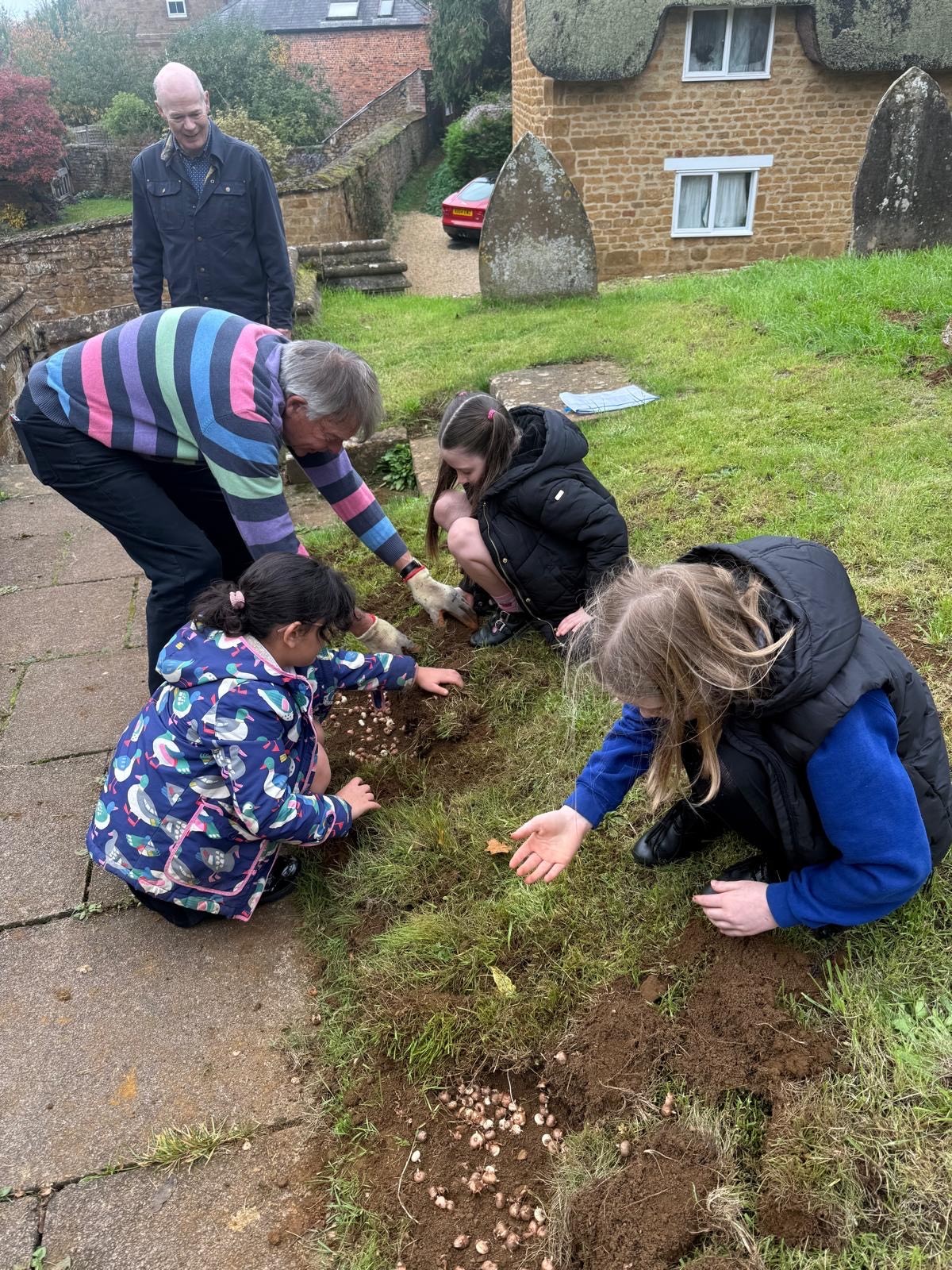 Wroxton Primary School students planting crocuses